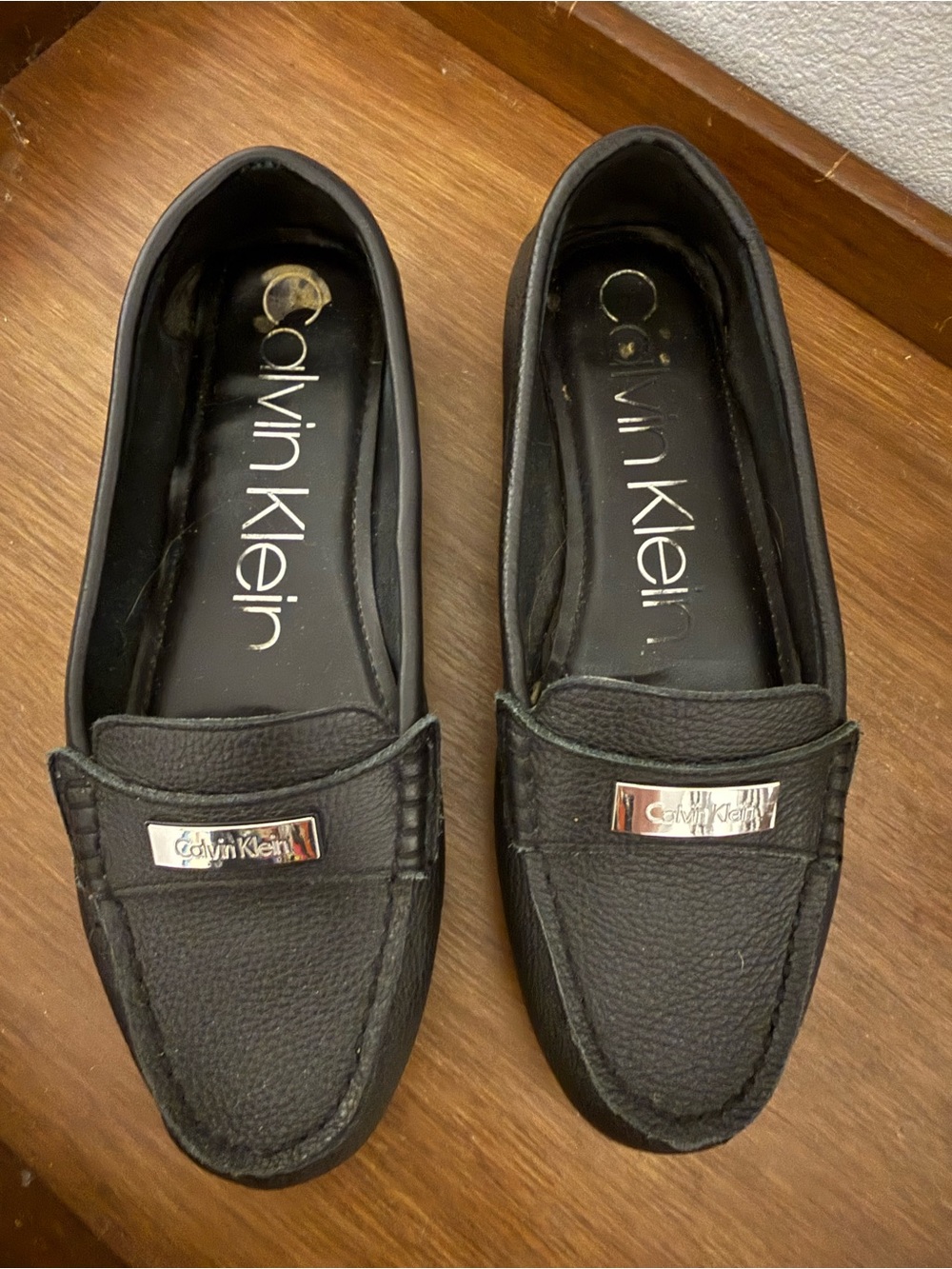 Calvin Klein Black Pebbled Leather Slip-On Loafers with Silver Plaque